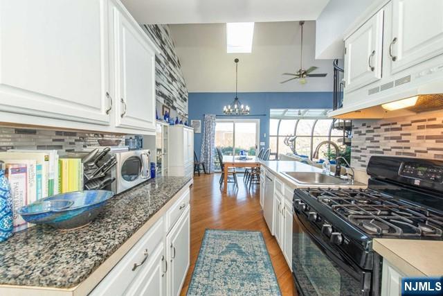 2 Falkenstein Drive, Unit 2 Vernon, NJ 07462 - Photo 2 of 24 a kitchen with stainless steel appliances granite countertop a stove a sink and a wooden cabinets
