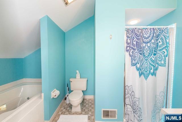 2 Falkenstein Drive, Unit 2 Vernon, NJ 07462 - Photo 21 of 24 a white toilet sitting next to a bathroom sink and tub