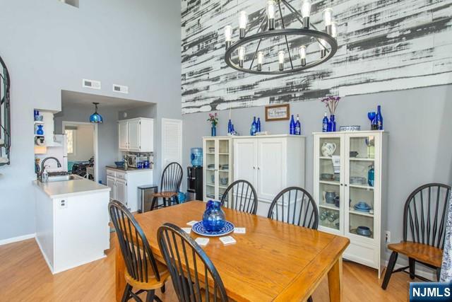 2 Falkenstein Drive, Unit 2 Vernon, NJ 07462 - Photo 5 of 24 a view of a dining room with furniture a chandelier and chandelier