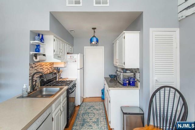 2 Falkenstein Drive, Unit 2 Vernon, NJ 07462 - Photo 10 of 24 a kitchen with stainless steel appliances granite countertop a refrigerator and a stove top oven