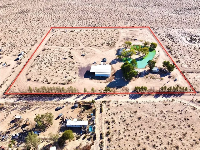 a kitchen with granite countertop a refrigerator and white cabinets