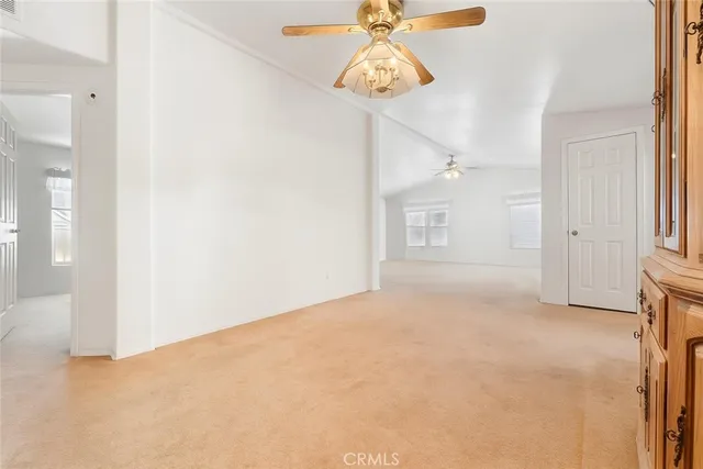 a view of a patio with table and chairs under an umbrella