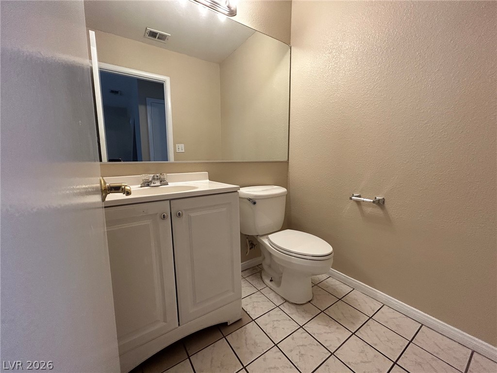 2806 Rungsted Street Las Vegas, NV 89142 - Photo 16 of 18 A compact and functional bathroom offering a simple vanity and toilet.