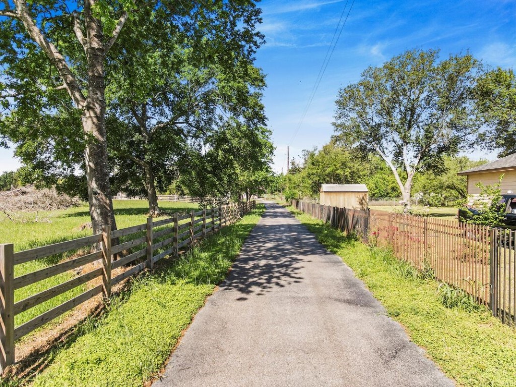 21645 Mueschke Road Tomball, TX 77377 - Photo 3 of 6 a view of a backyard with pathway