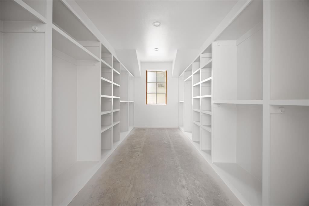 9220 Ferndale Road Dallas, TX 75238 - Photo 27 of 30 Custom built-in shelving, integrated storage compartments, and a window with natural light