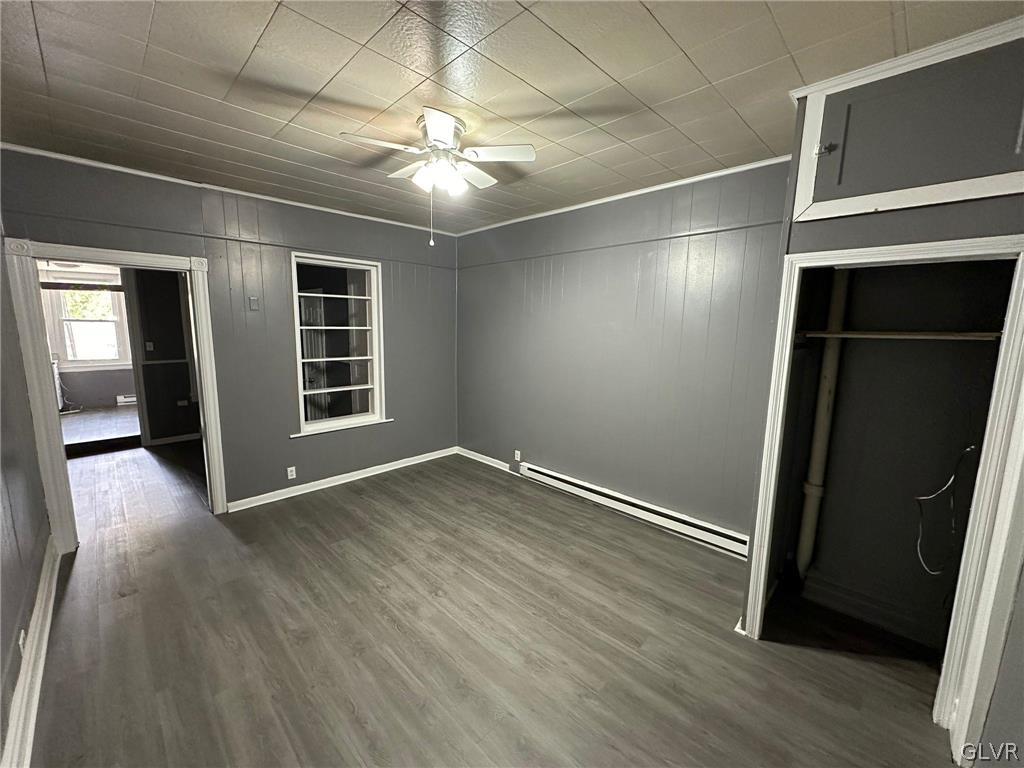 425 Liberty Street, Unit 1 Allentown, PA 18102 - Photo 3 of 13 an empty room with wooden floor and windows