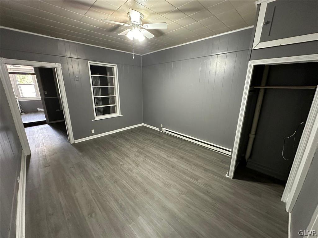 425 Liberty Street, Unit 1 Allentown, PA 18102 - Photo 4 of 13 an empty room with wooden floor and windows