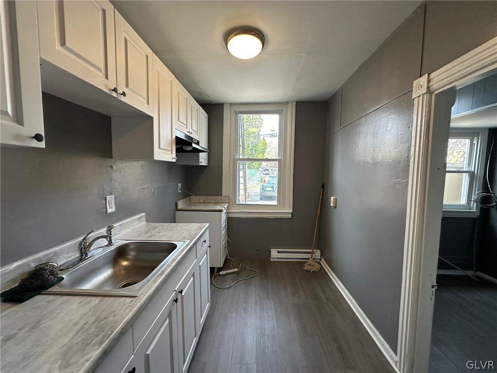 425 Liberty Street, Unit 1 Allentown, PA 18102 - Photo 7 of 13 a kitchen with a sink a stove and cabinets