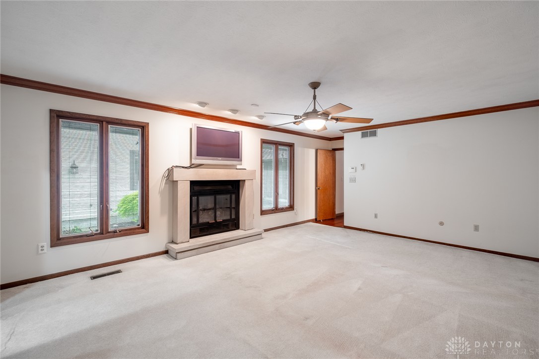 273 North Alpha Bellbrook Road Dayton, OH 45434 - Photo 23 of 43 This expansive living area features a charming fireplace and bright windows, perfect for relaxation and gatherings.