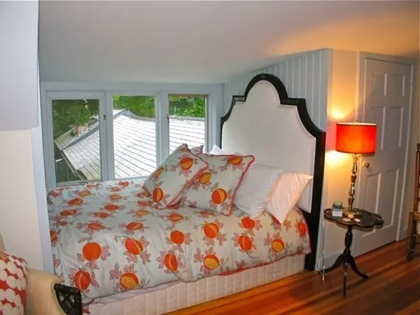a bedroom with a bed and window