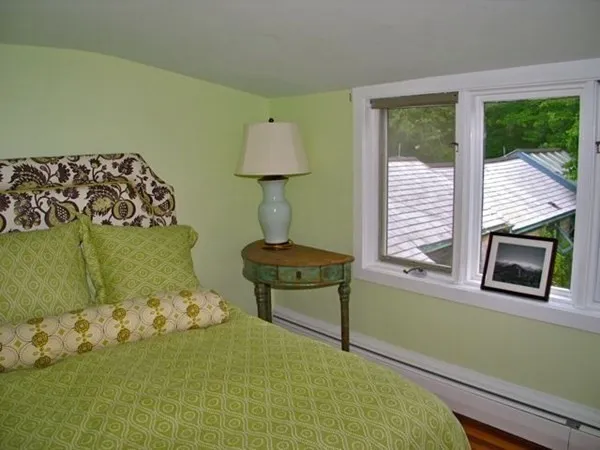 a bedroom with bed and a window