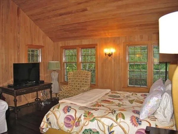 a bedroom with a bed and a flat screen tv