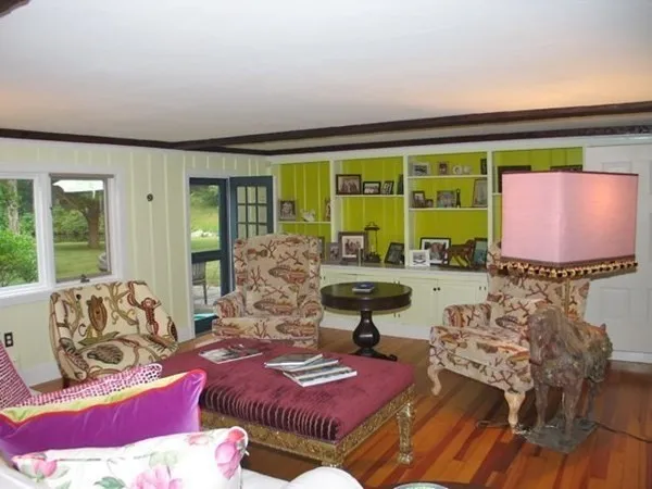 a living room with furniture and a floor to ceiling window