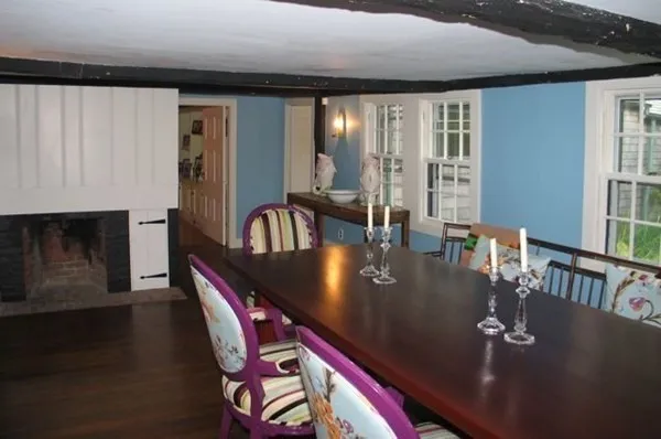 a kitchen with stainless steel appliances granite countertop table chairs and a living room