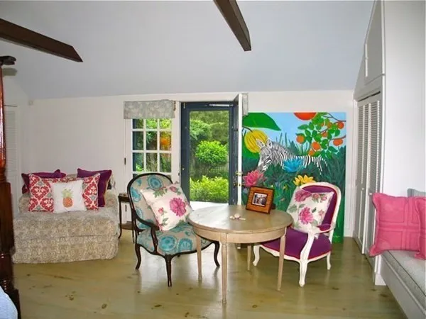 a living room with furniture fireplace and a large window