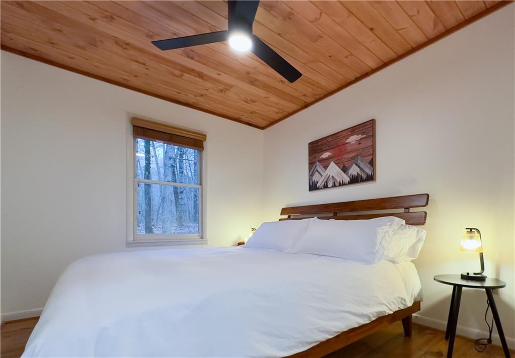 357 Mystic Lane Blue Ridge, GA 30513 - Photo 19 of 58 a bedroom with a bed and wooden floor