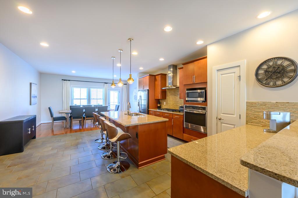 20649 Duxbury Terrace Ashburn, VA 20147 - Photo 12 of 41 a large kitchen with a table and chairs