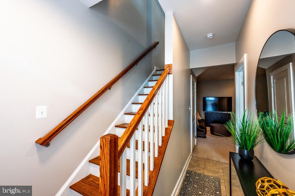 20649 Duxbury Terrace Ashburn, VA 20147 - Photo 3 of 41 a hallway with wooden floor stairs and furniture