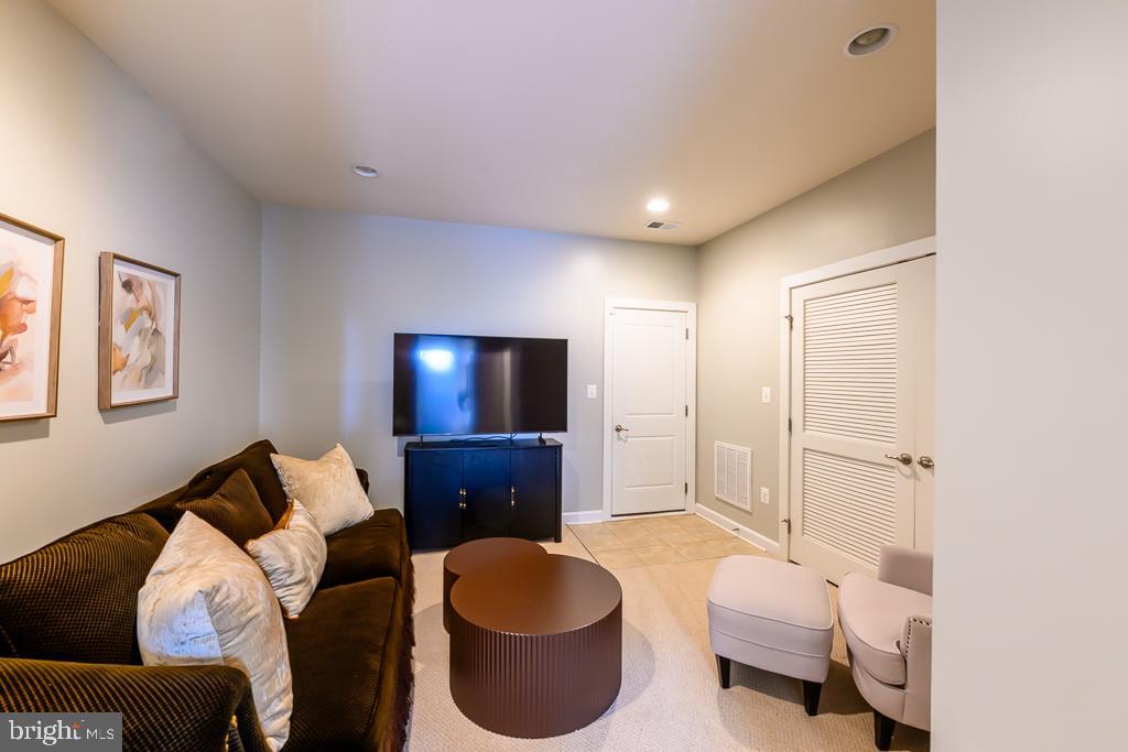 20649 Duxbury Terrace Ashburn, VA 20147 - Photo 4 of 41 a living room with furniture and a flat screen tv