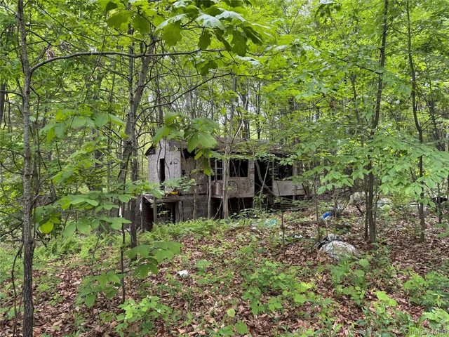a view of an house with backyard space and sitting area