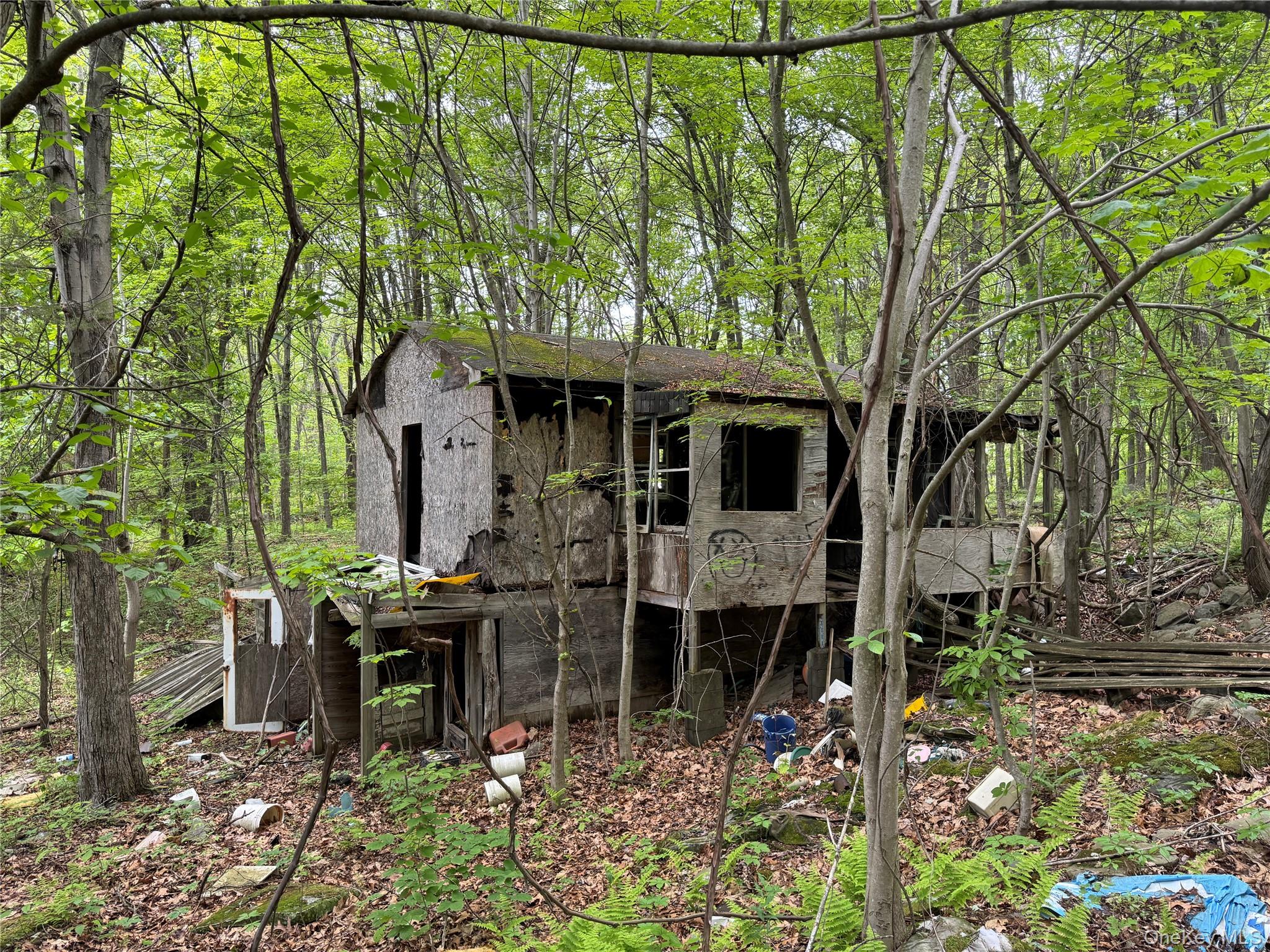 24 Saul Trail Wallkill, NY 12589 - Photo 4 of 8 a view of a chair and table in backyard of the house