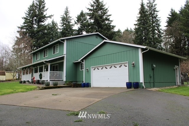4910 193rd Lane Southwest Rochester, WA 98579 - Photo 2 of 25 a front view of a house with a garage
