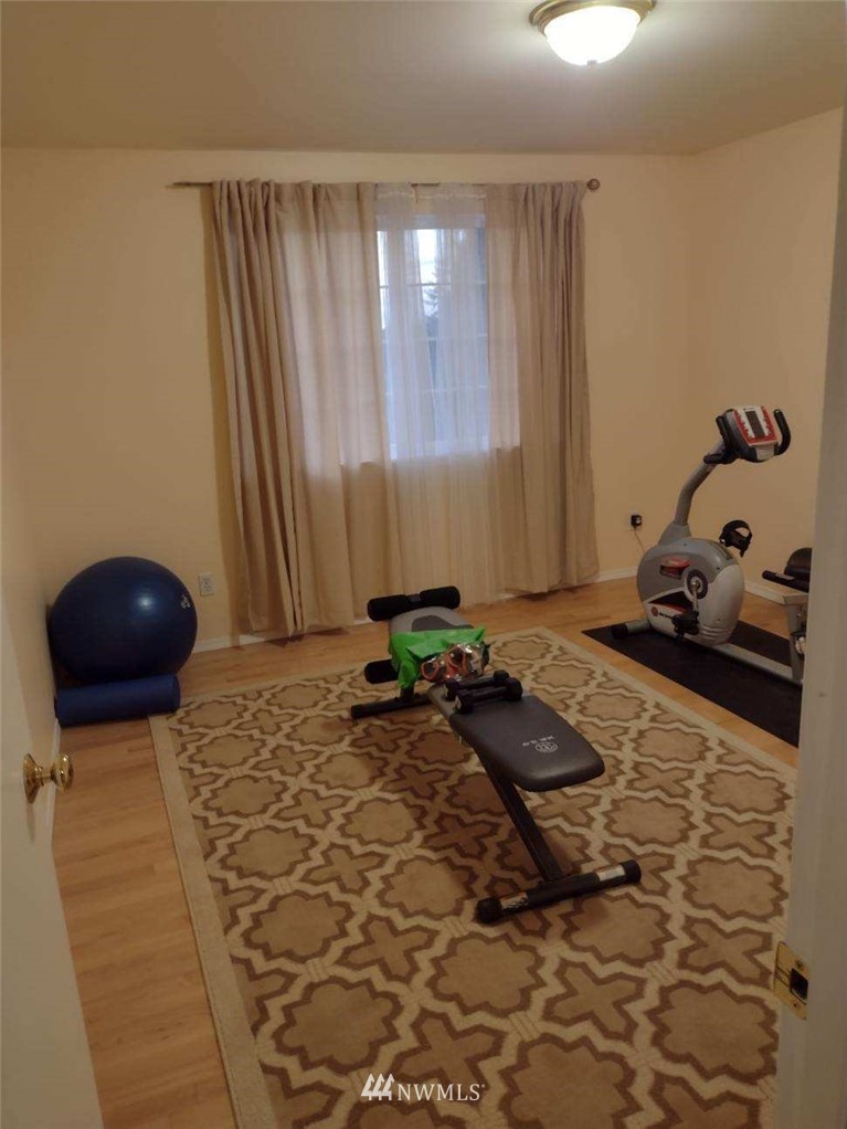 4910 193rd Lane Southwest Rochester, WA 98579 - Photo 19 of 25 a room with a rug and a chair