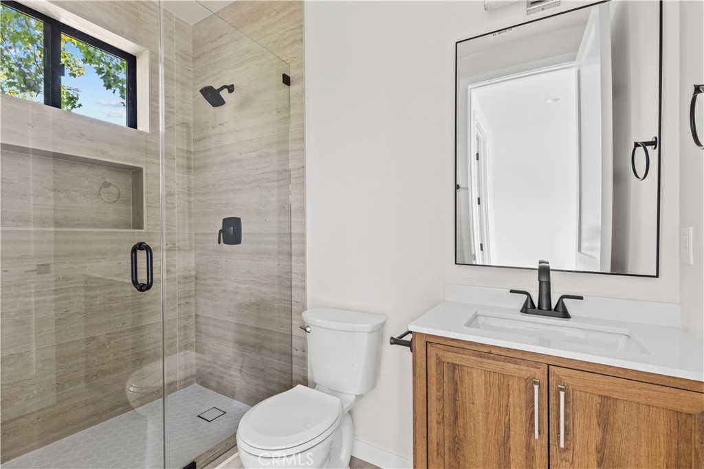 11145 Hortense Street North Hollywood, CA 91602 - Photo 11 of 15 a bathroom with a sink a toilet and shower