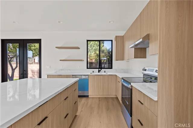 a kitchen with a sink stove and cabinets