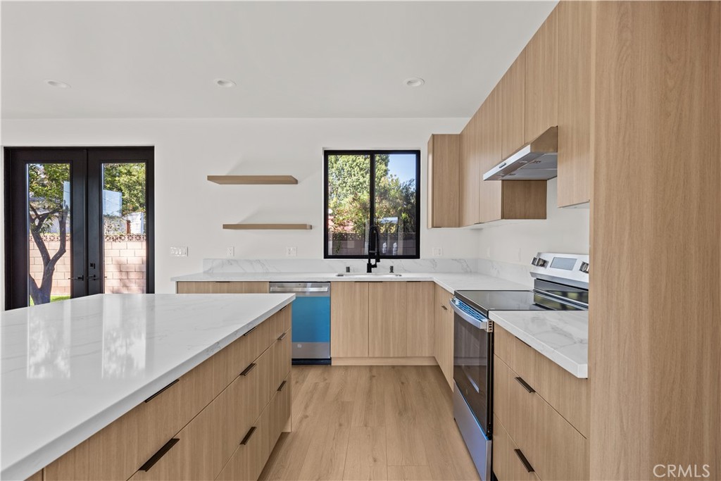 11145 Hortense Street North Hollywood, CA 91602 - Photo 5 of 15 a kitchen with a sink stove and cabinets