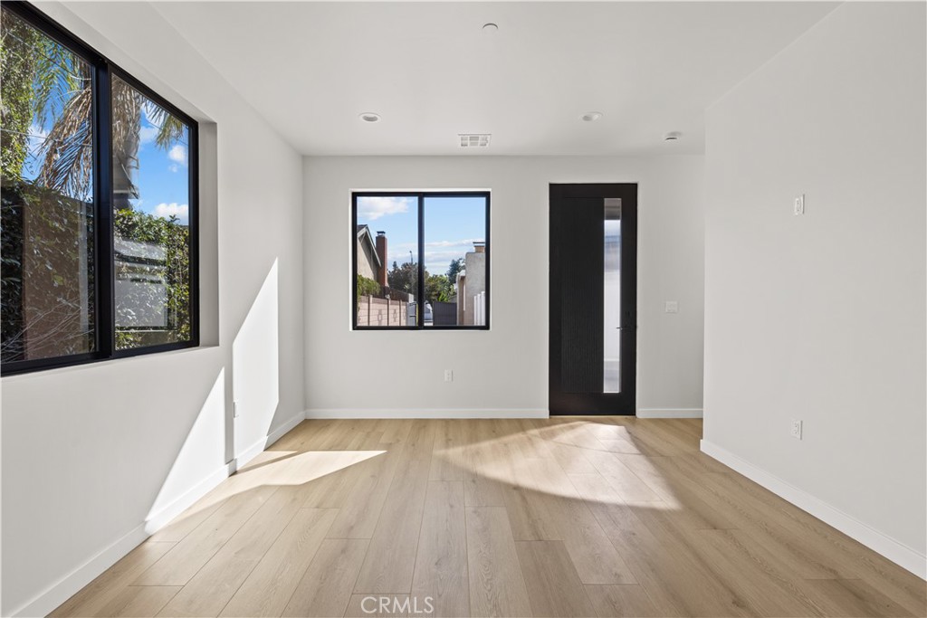 11145 Hortense Street North Hollywood, CA 91602 - Photo 7 of 15 a view of empty room with wooden floor and fan