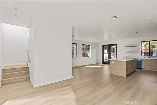 a view of empty room with wooden floor and fireplace