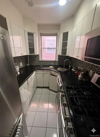 a kitchen with a sink a stove and a microwave