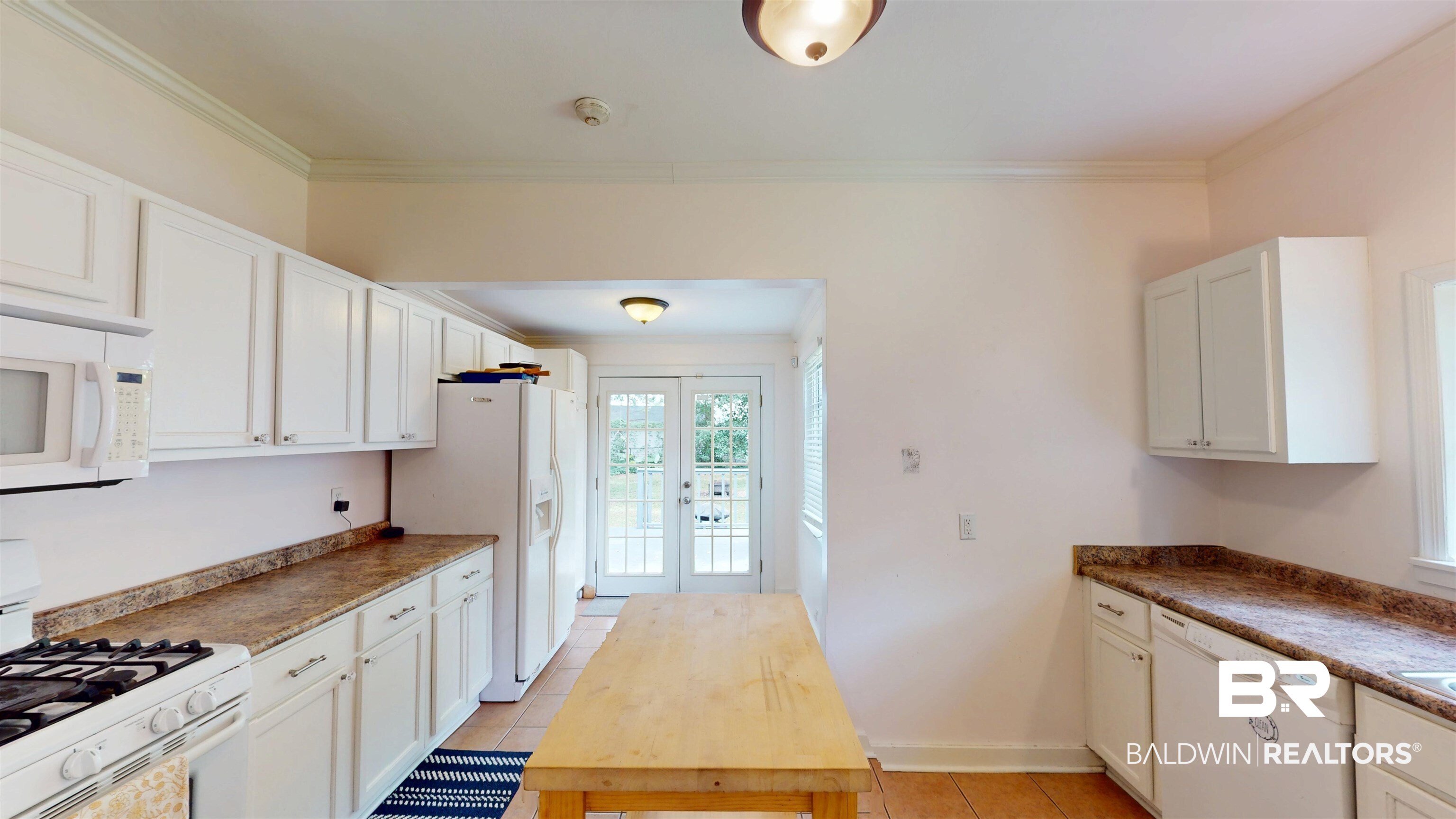 266 Westwood Street Mobile, AL 36606 - Photo 14 of 34 Kitchen featuring white appliances, french doors, ornamental molding, light tile patterned floors, and white cabinetry