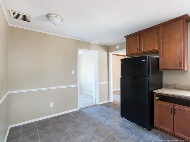 a kitchen with a refrigerator and cabinets