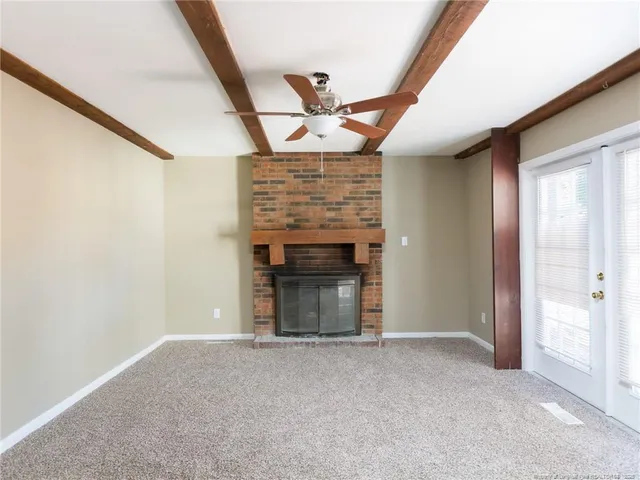 a view of an empty room with a fireplace