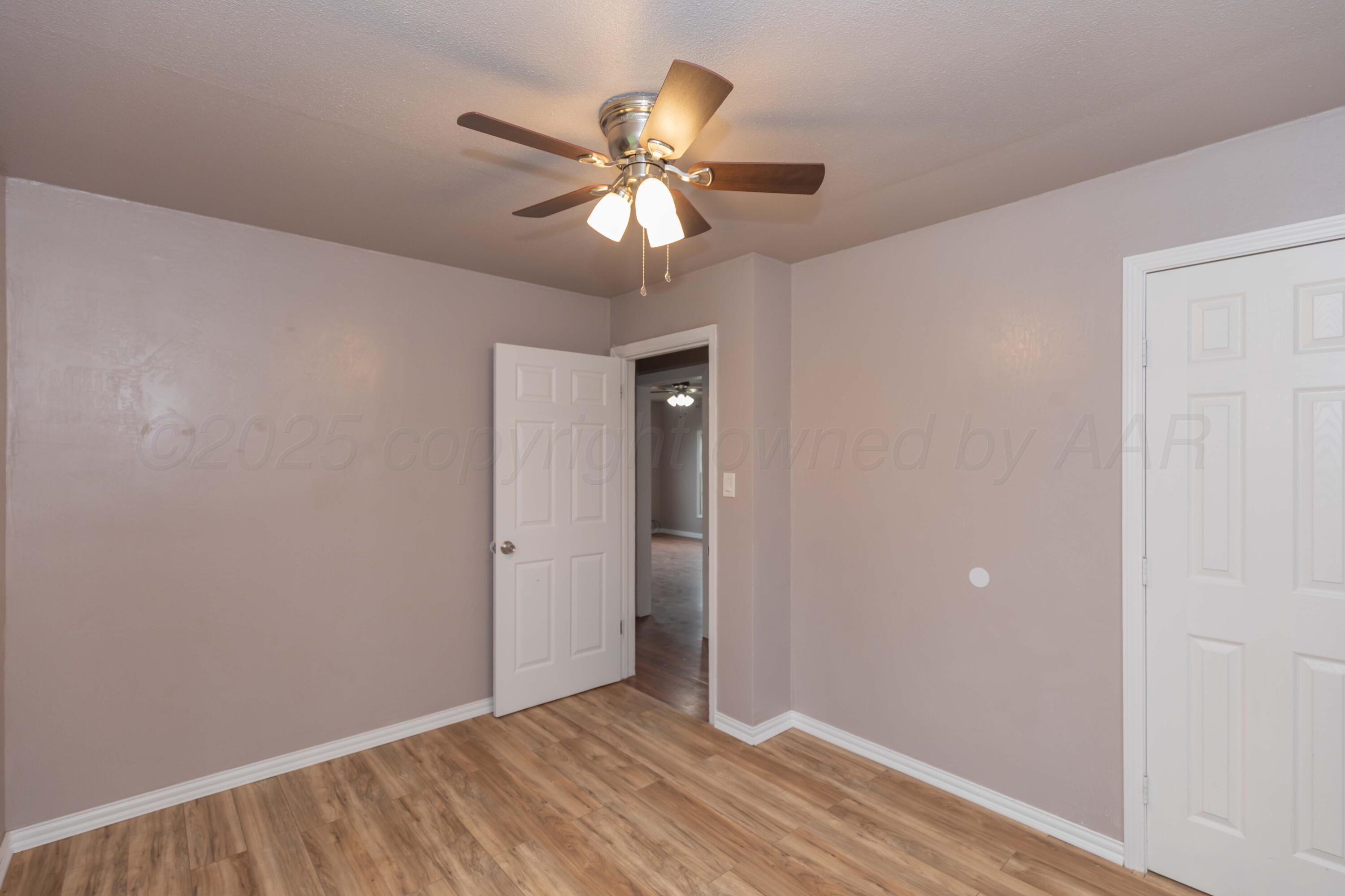 1307 North Buchanan Street Amarillo, TX 79107 - Photo 15 of 31 a view of an empty room with wooden floor
