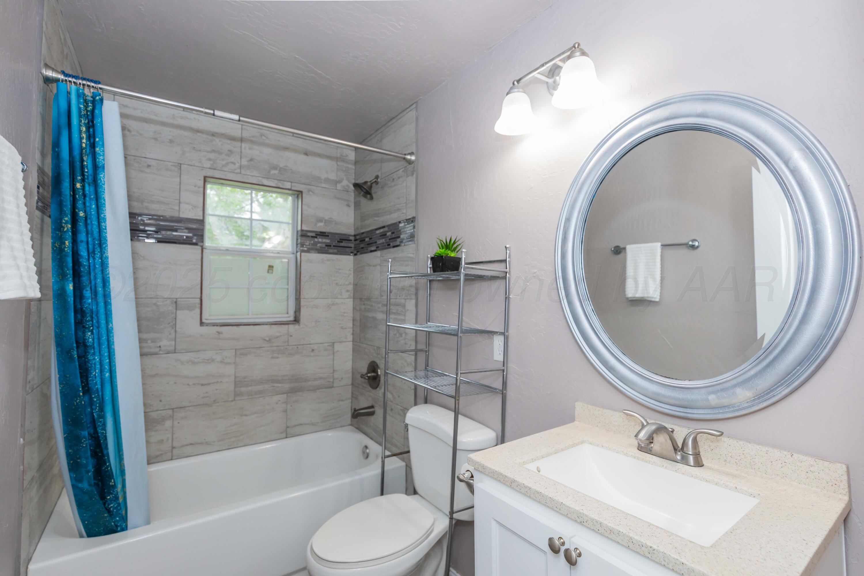 1307 North Buchanan Street Amarillo, TX 79107 - Photo 16 of 31 a bathroom with a sink toilet and shower