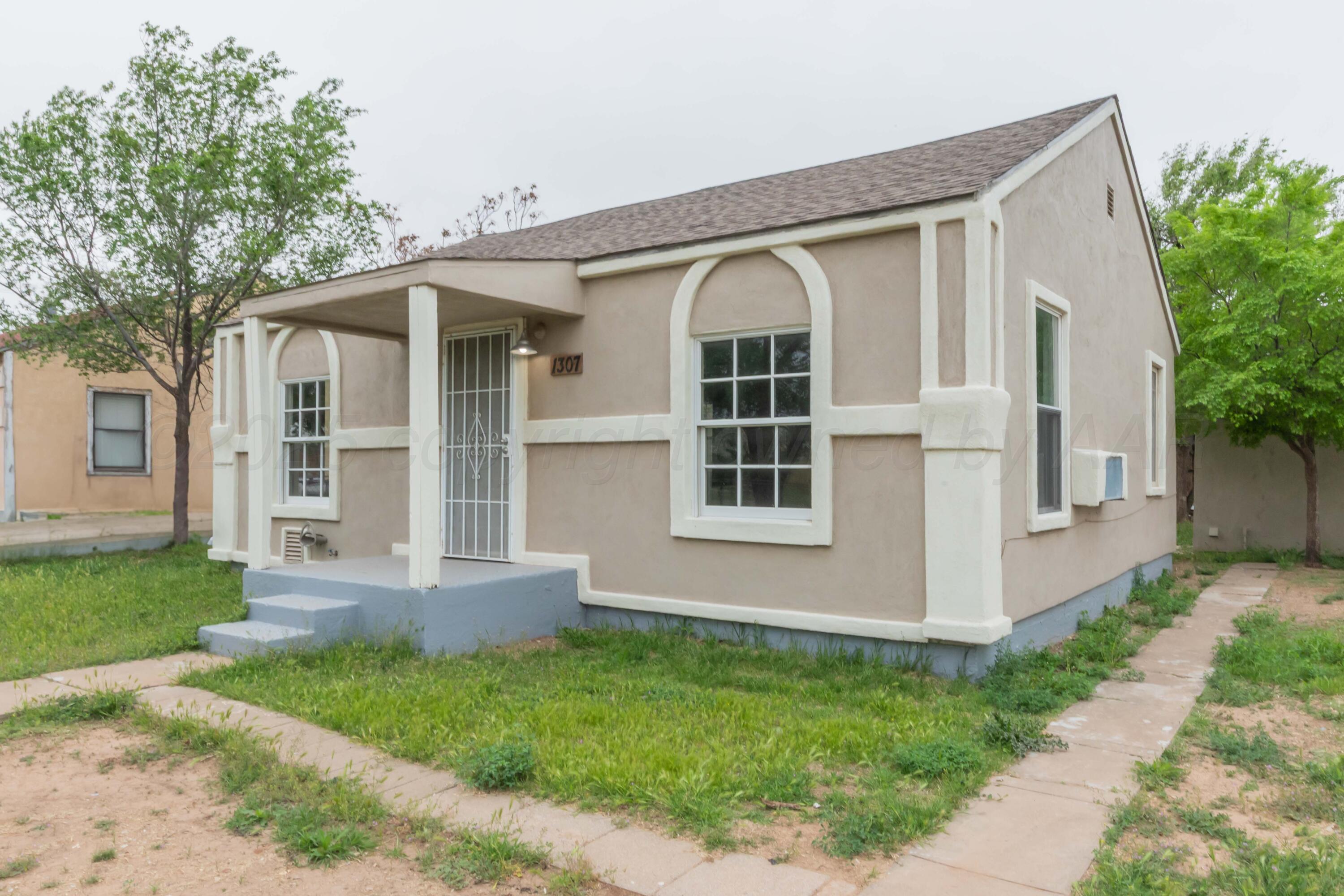 1307 North Buchanan Street Amarillo, TX 79107 - Photo 2 of 31 a front view of a house with a yard