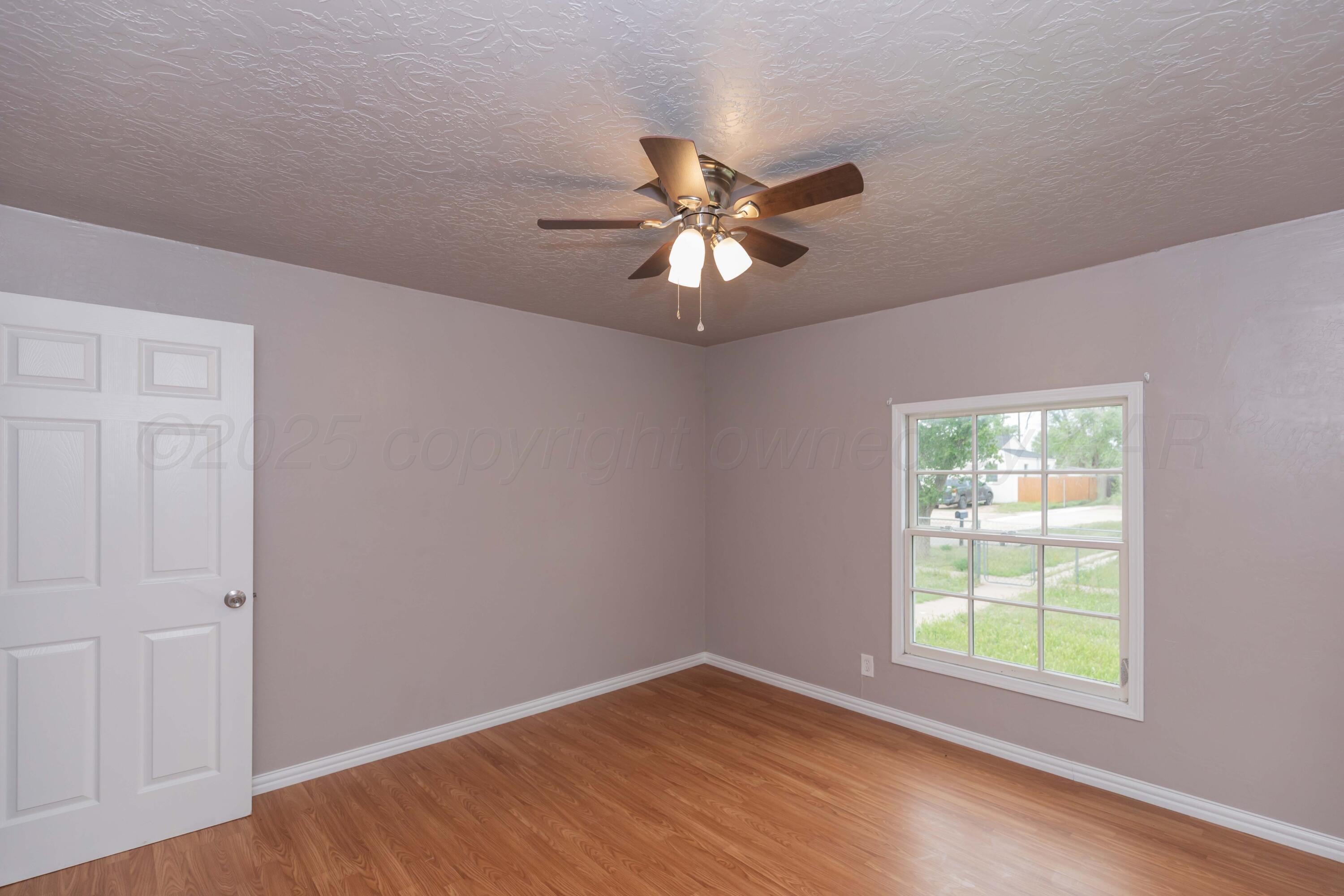 1307 North Buchanan Street Amarillo, TX 79107 - Photo 22 of 31 an empty room with a window and a fan