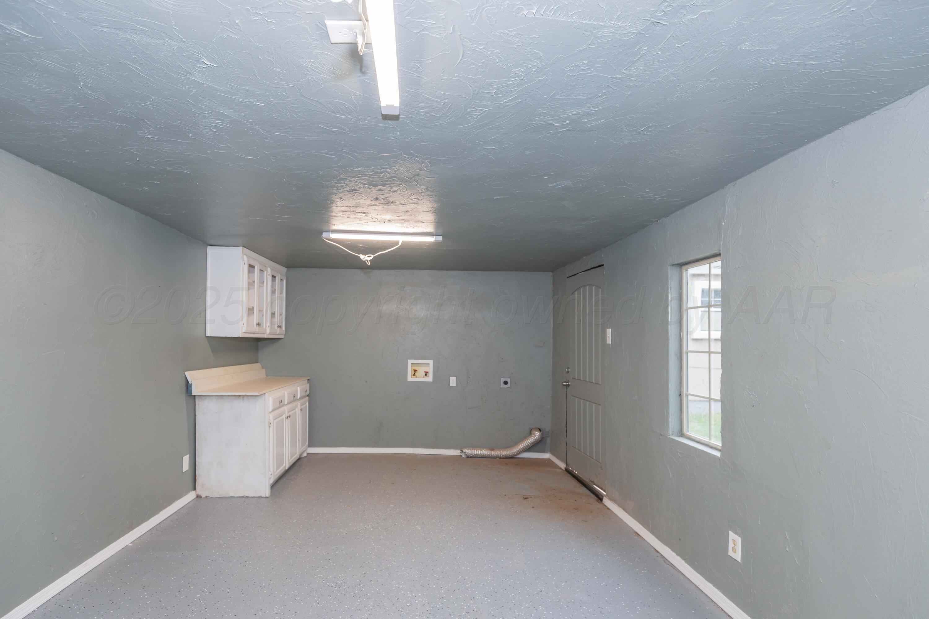 1307 North Buchanan Street Amarillo, TX 79107 - Photo 27 of 31 an empty room with a window and wooden floor