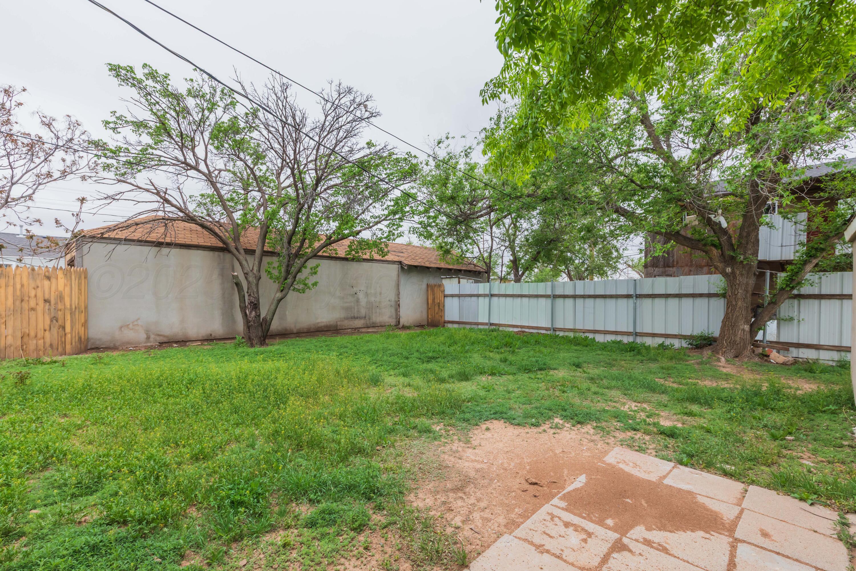 1307 North Buchanan Street Amarillo, TX 79107 - Photo 28 of 31 a view of a backyard with large trees