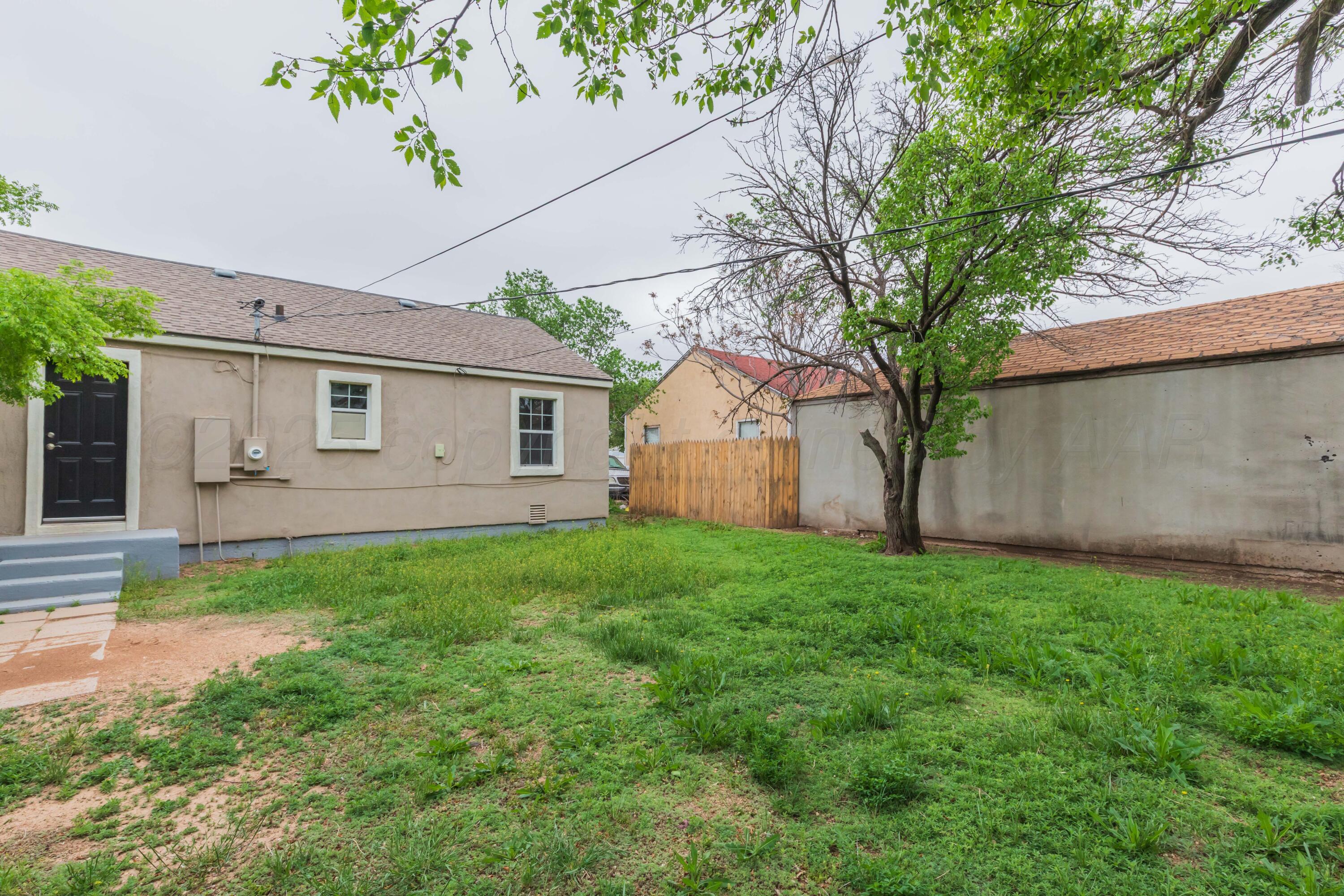 1307 North Buchanan Street Amarillo, TX 79107 - Photo 29 of 31 a view of a backyard with plants and large tree