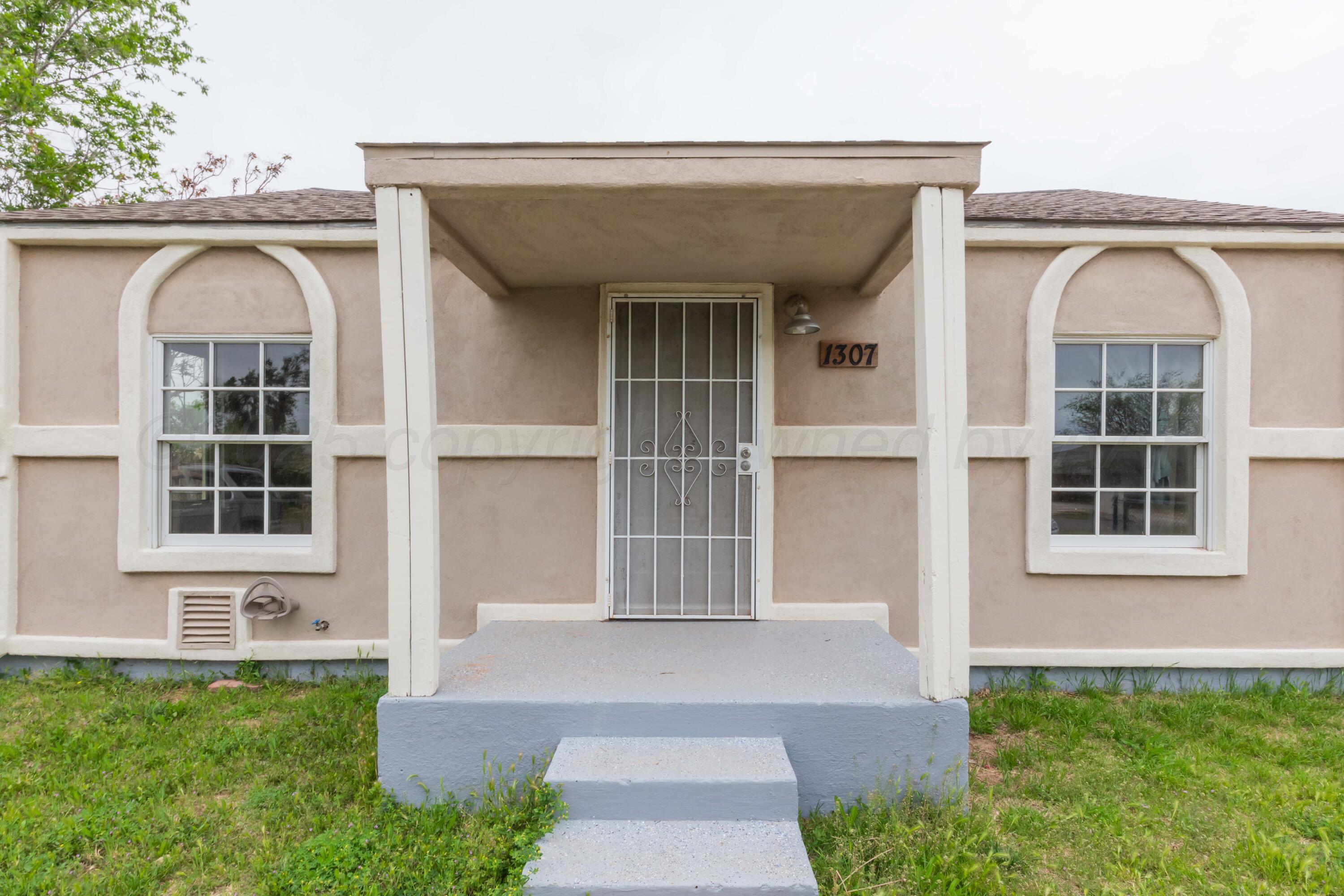 1307 North Buchanan Street Amarillo, TX 79107 - Photo 3 of 31 a front view of a house with a yard