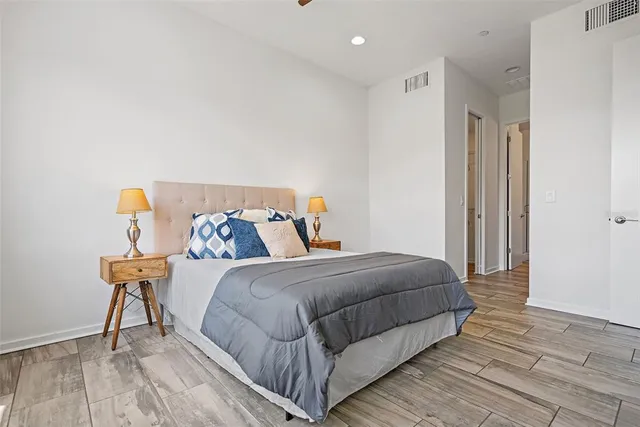 a bedroom with a bed and wooden floor