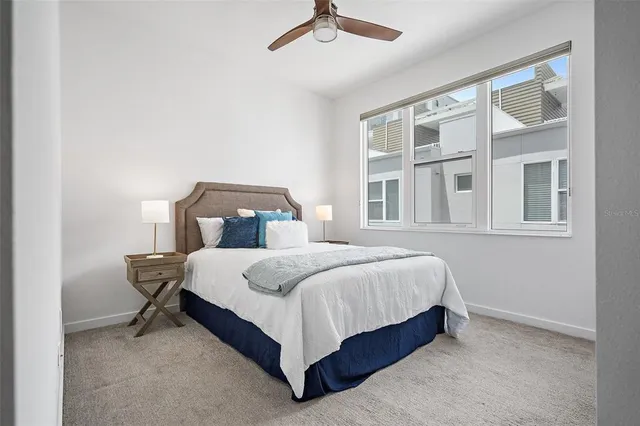 a bed sitting in a bedroom next to a window