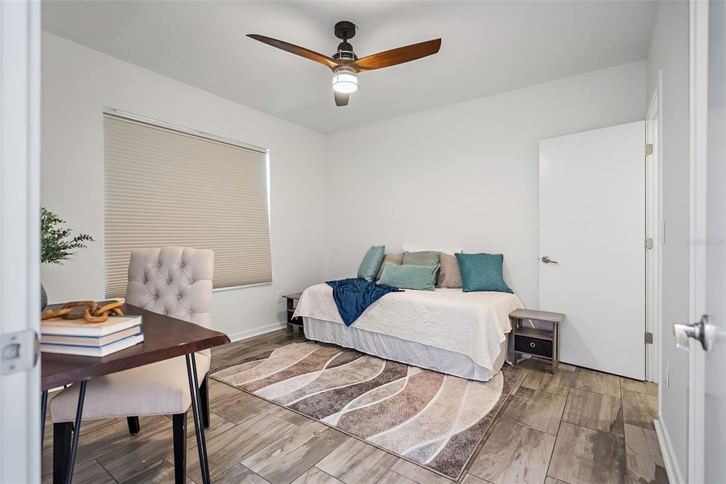 755 Calla Terrace North St. Petersburg, FL 33701 - Photo 19 of 37 a bedroom with a bed and a table in it