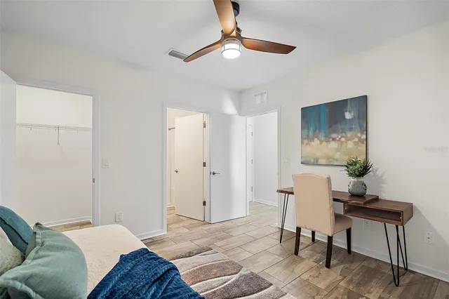 a bedroom with a bed and a chair