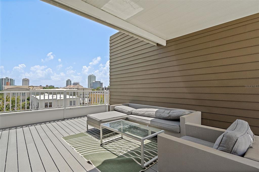 755 Calla Terrace North St. Petersburg, FL 33701 - Photo 23 of 37 a balcony with wooden floor and furniture