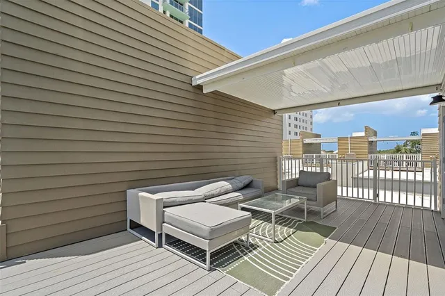 a balcony with table and chairs